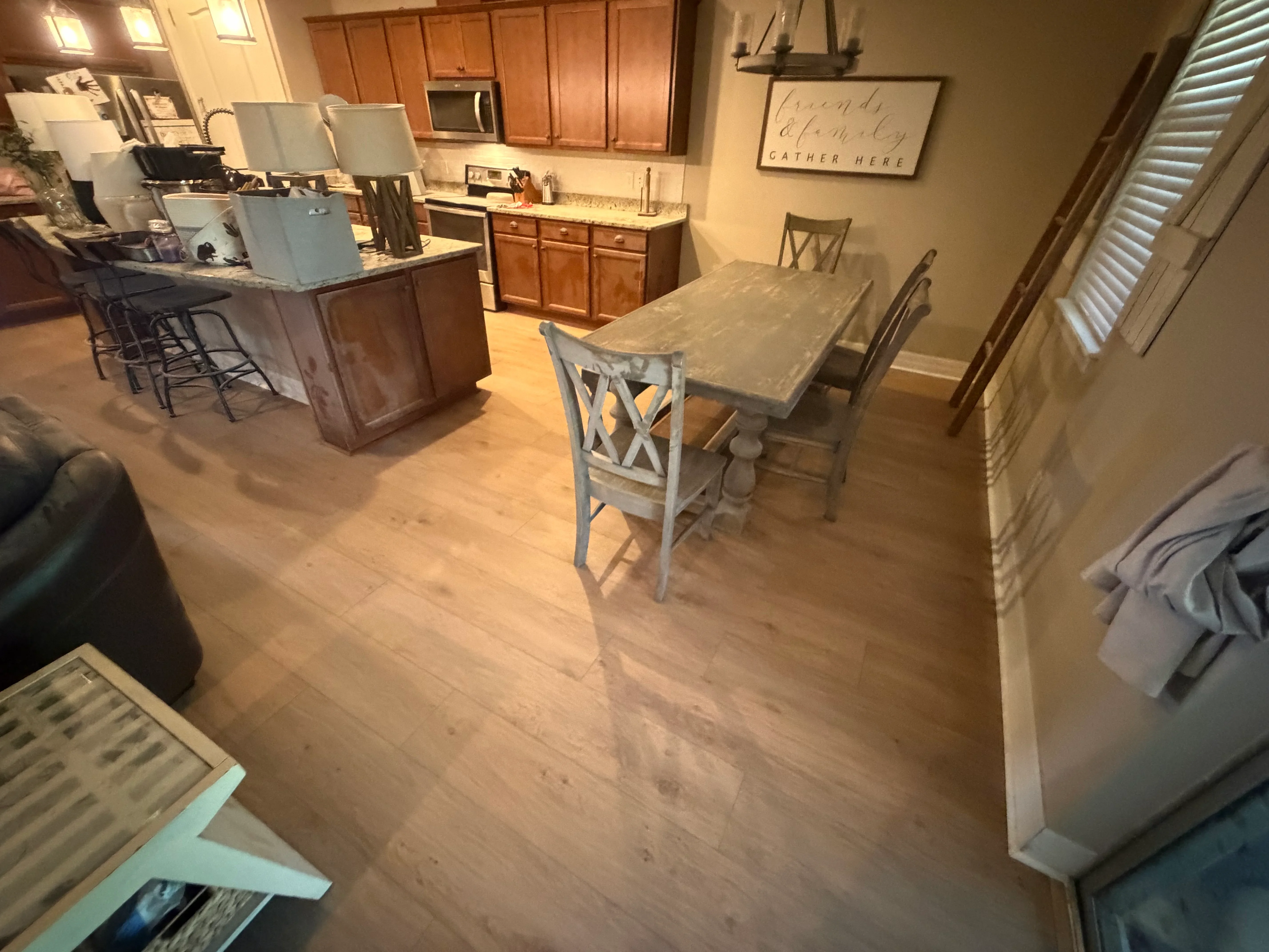 Light oak engineered wood flooring in open kitchen and dining area with wood cabinetry