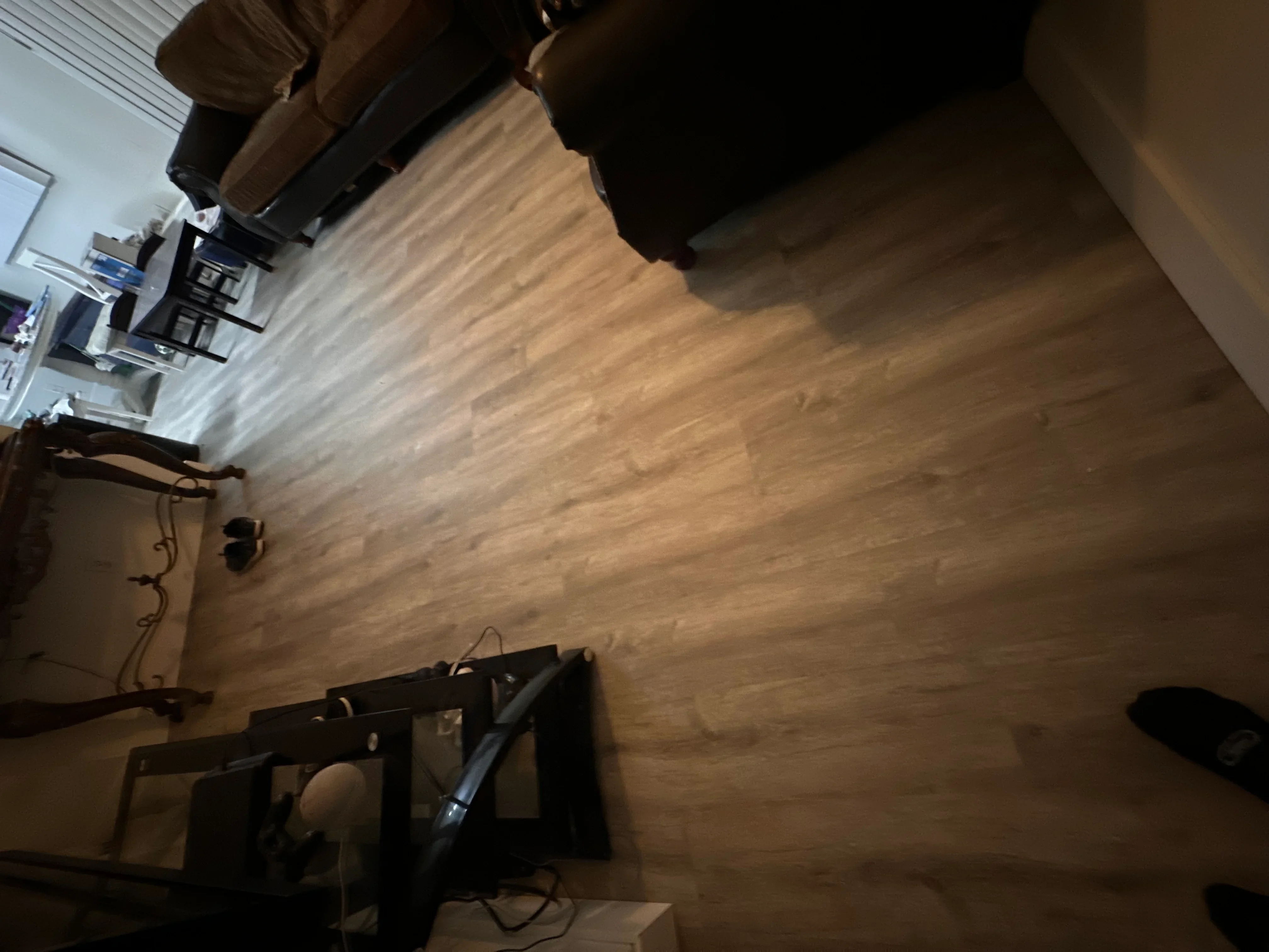 Newly installed luxury vinyl plank flooring in kitchen with wood-grain finish
