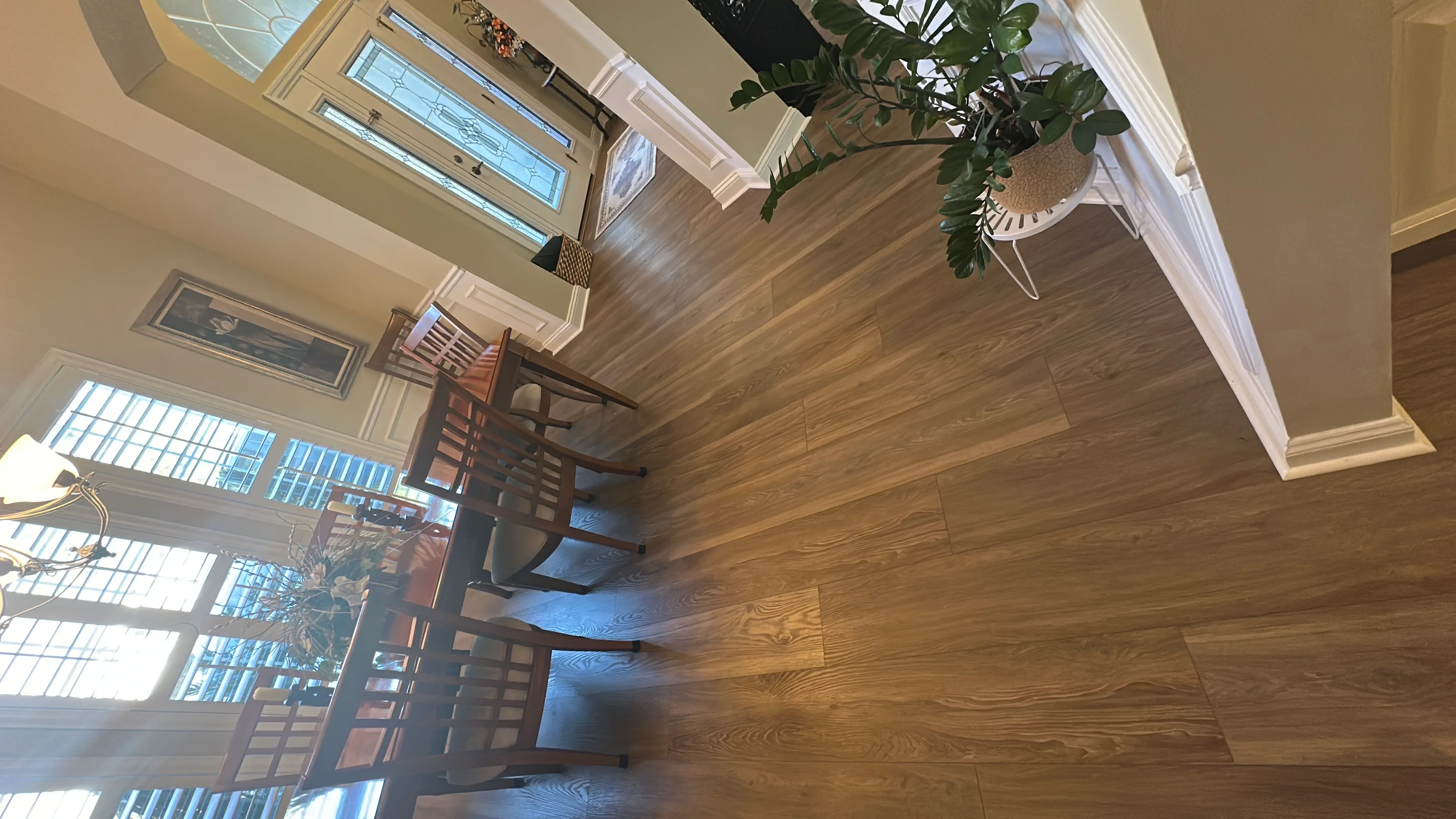 Medium-tone oak hardwood flooring installed in living room with white trim and baseboards