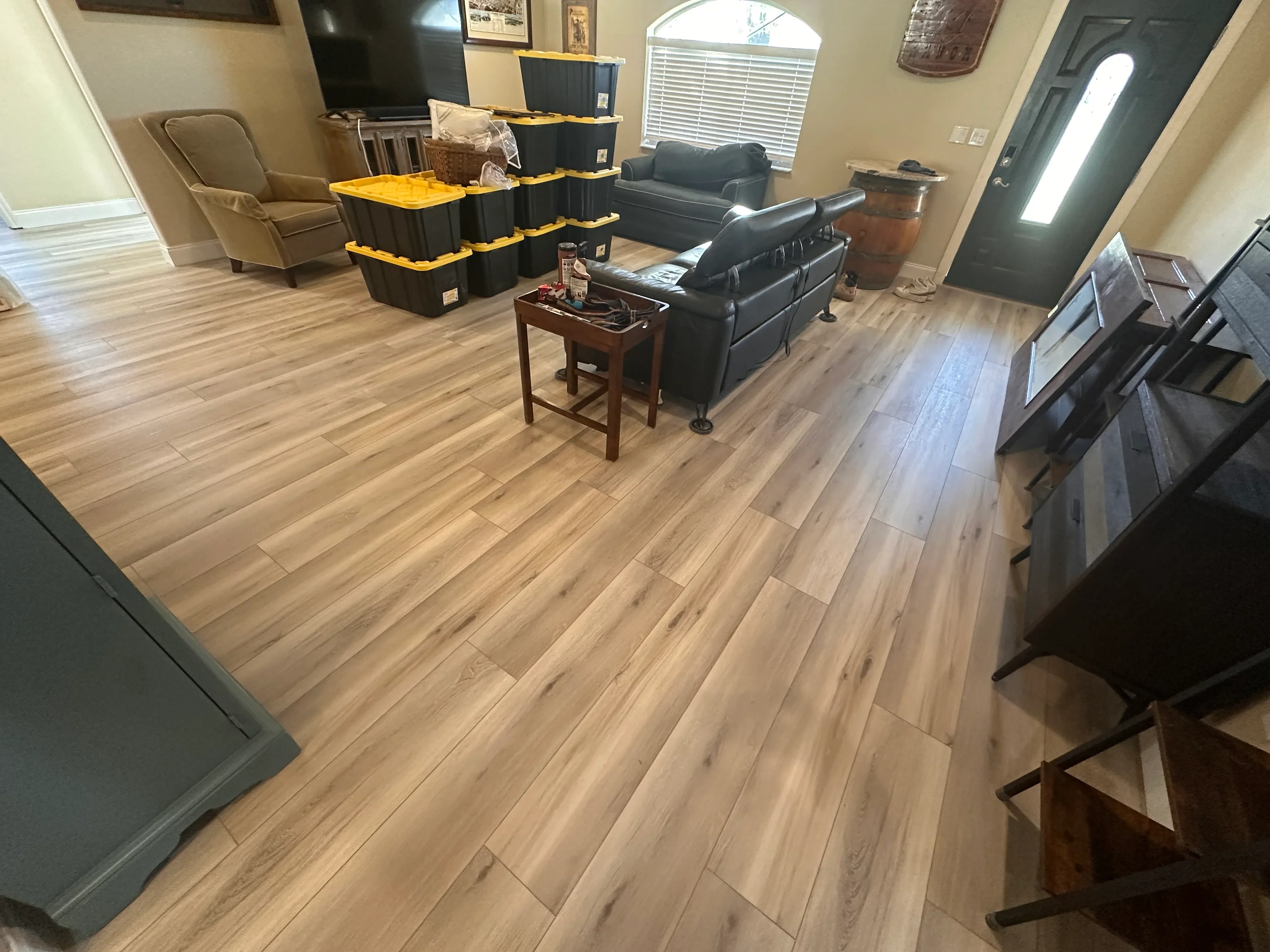 Luxury vinyl plank flooring in wood-grain finish installed in living room with staggered pattern